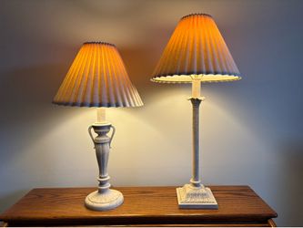 Vintage Pair Of Ornate Neoclassical Style Table Lamps, with heavy distressed style bases and pleated fabric shades, 30” and 25” tall, 6” bases and 14”