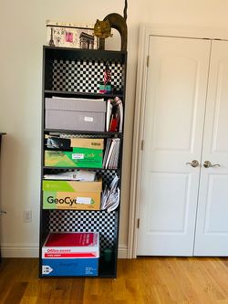 Bookcase/Shelf Unit. Dark brown. Very capacious. Excellent condition. Great bargain. Nice checkered pattern background. 71.25” tall. 24.75 x 11.50”.