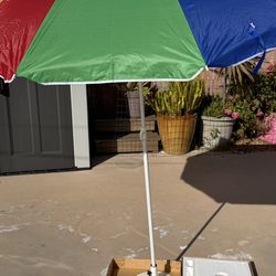 Brand new beach umbrella with base