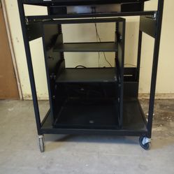 A/V Cart on rollers with built-in audio speakers and Power strip.