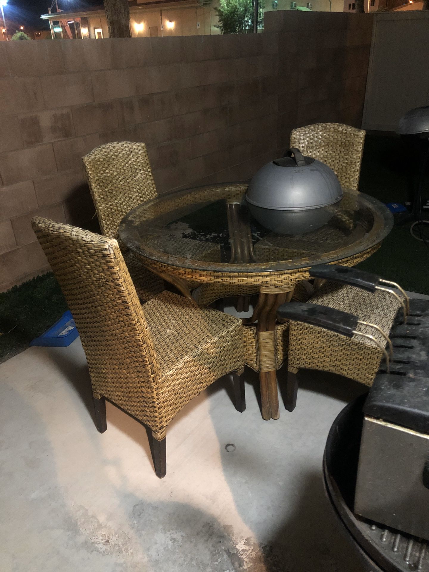 $50 Pier one wicker patio set. Table in excellent condition. 4 chairs, 1 chair is worn but still manageable.