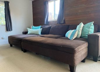 Comfortable brown L-shaped couch with storage ottoman
