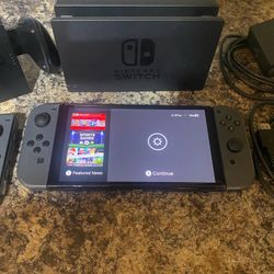 Nintendo switch W/ 1 new game  and the Dock & cords and one controller attachment asking 140$ obo
