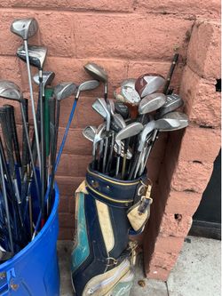Lot of golf clubs all mixed