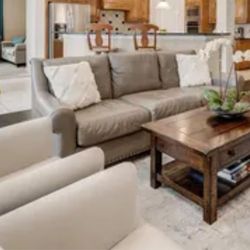 Leather sofa and white side chairs