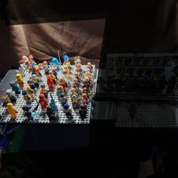 LEGOS. FIGURES  Think A Little Over 50 Of Them ,  Right Side Are All Harry Potter, Next Is Jurassic Park,    Super Heros ,