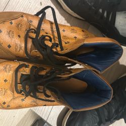 MCM Visetos High-Top Sneakers in the brand's signature cognac (honey) color. 