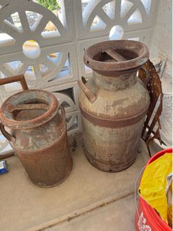 Antique rustic milk and creamer containers.