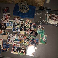 Basketball card baseball cards and football cards and a toy