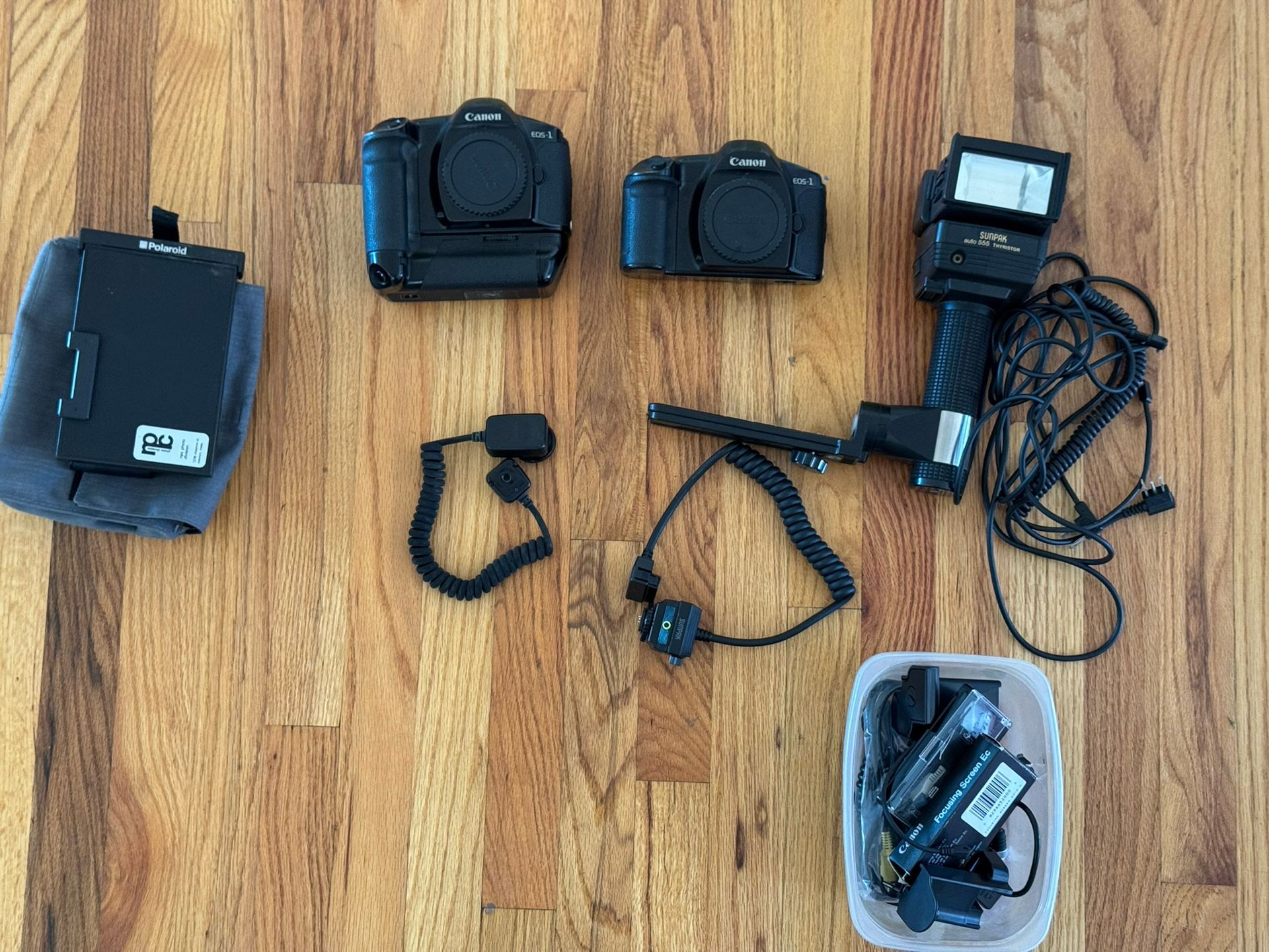 2 Vintage Canon Eos 1’s, NPC Polaroid back, Sun pack 555 flash gun plus extras