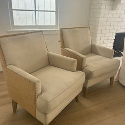 Club chairs with metal bullet heads on sides. Natural Linen Color With Natural textured fabric on the back.