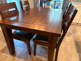 Dining Table with 4 chairs and a bar/hutch/buffet