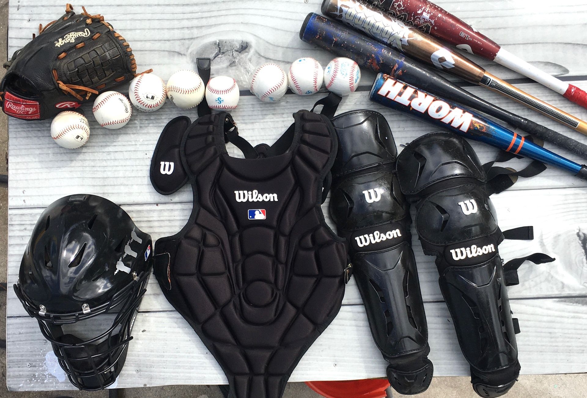 Baseball pads,helmet,bat, and balls.