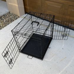 black metal wire folding dog crate. 24 To 18 To 21 Inches. New, 2 Doors
