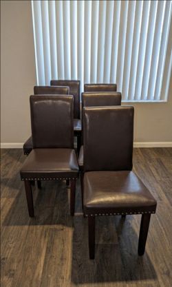 Set of 6 dark brown chairs with nailhead trim.