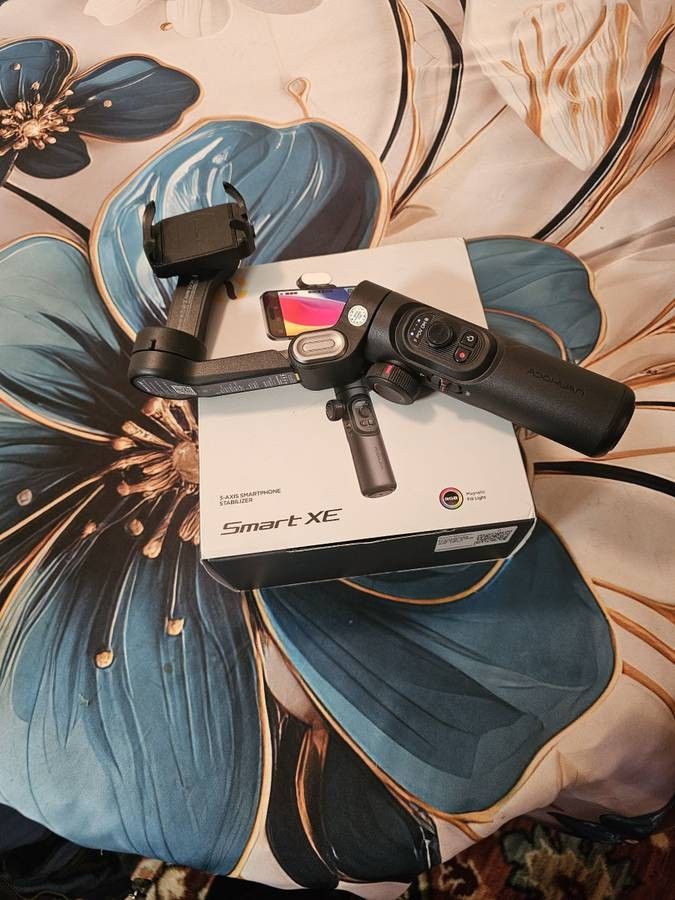 BRAND NEW AOXHUAN SMART PHONE XE AI GIMBAL STABILIZER, FOLDABLE AND ANTI SHAKE AND 360 DEGREE ROTATION AND AUTOMATIC FACE TRACKING FOR PANAROMA SHOOT