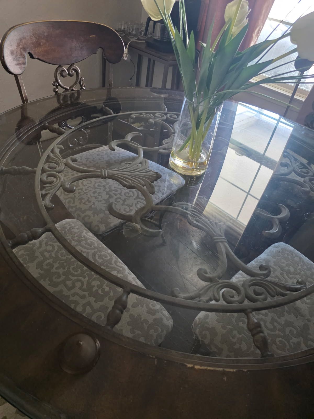 Metal table frame seats for people glass top no cracks no damages. Chairs are in decent condition. Comes with all four chairs moving need to sell ASAP