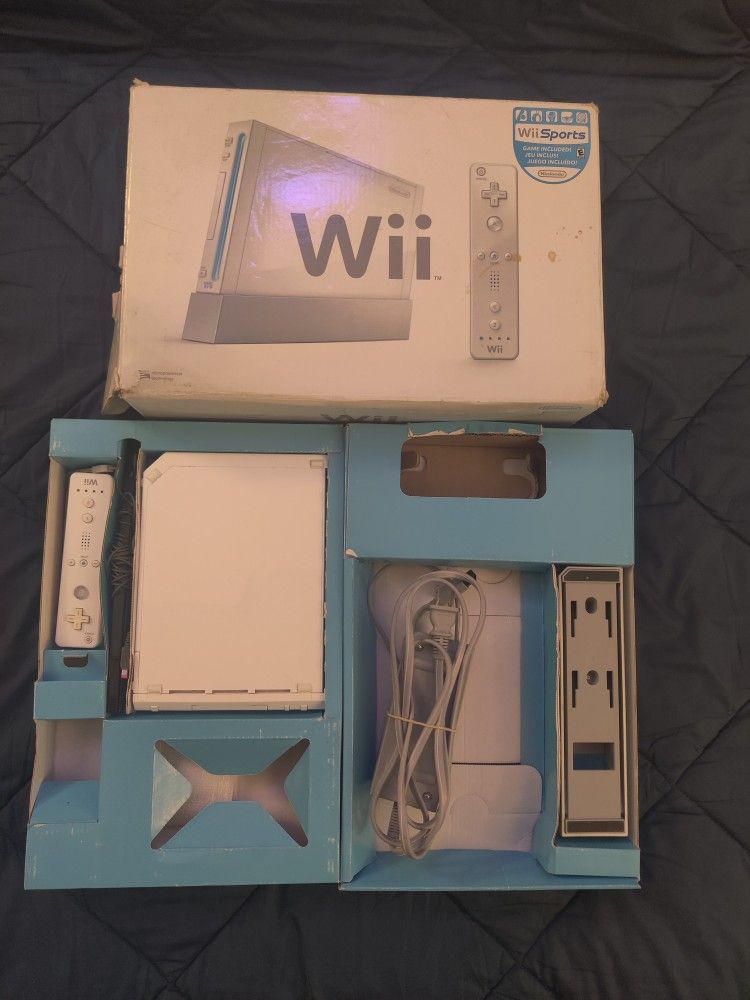 Nintendo Wii with a box, controller, sensor bar, power supply, system stand.