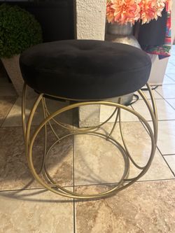 Round black velvet ottoman