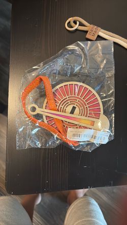 Portable wrist yarn holder (often called a "Mini Minder" or yarn caddy)