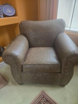 Two brown leather chairs. No rips tears .