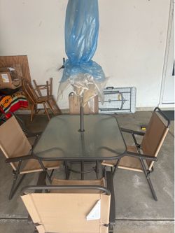 Patio table, chairs, and umbrella