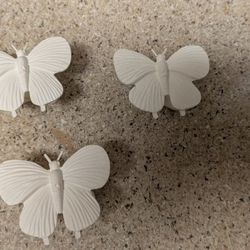 Set of 3 butterfly wall hooks. Dimensions: 3” wide, 2.5” tall, 1” deep. 