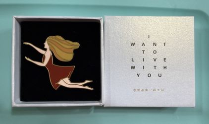 Enamel Pin of Woman in Red Dress with Gift Box