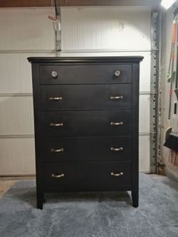 Refurbished black Ashley Furniture five drawer dresser.
