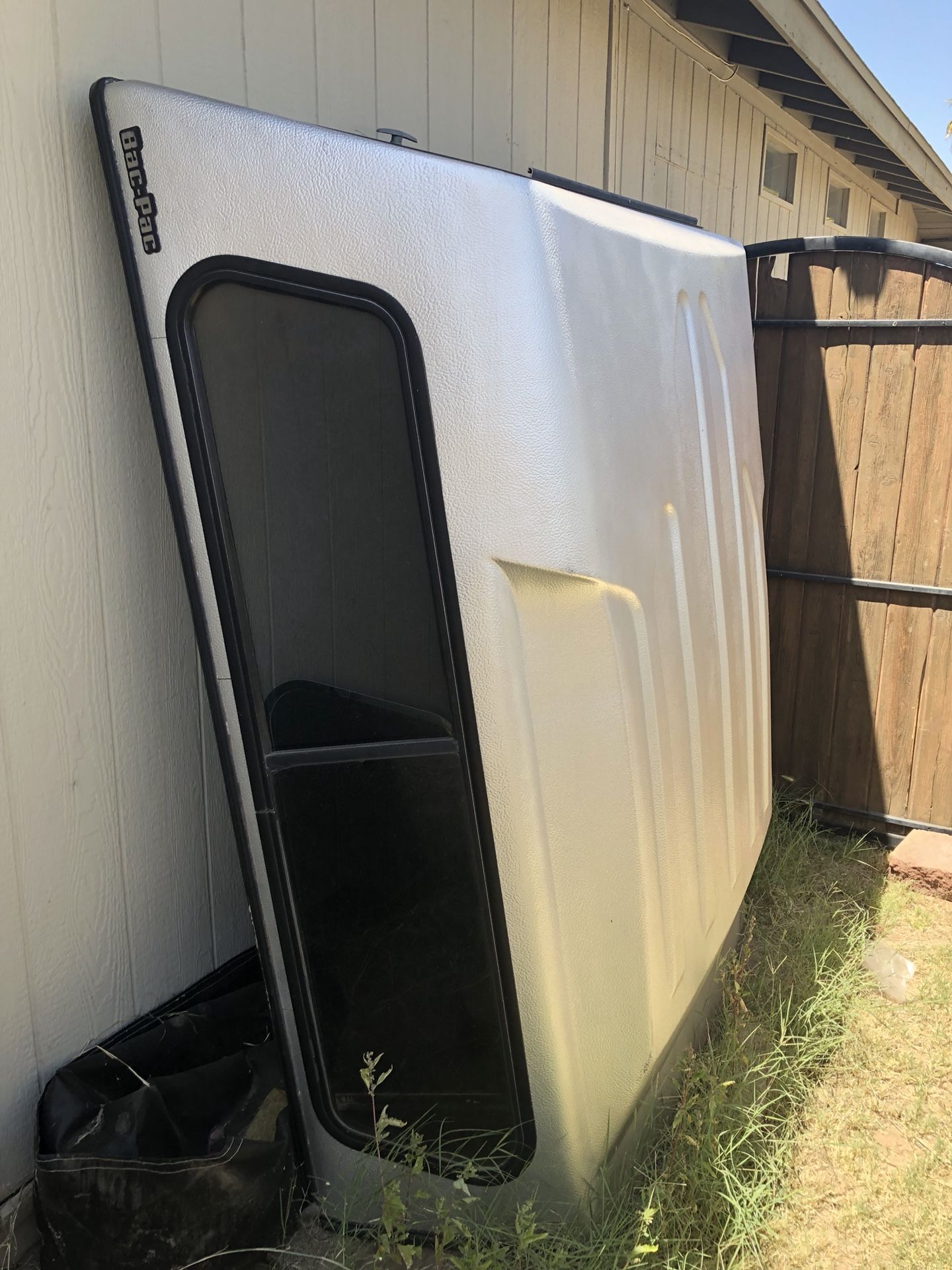 Bac Pac camper shell, silver. Fits my 2004 Ford ranger xlt truck. Slight damage. Cracking on various areas of shell. All the windows and screens are