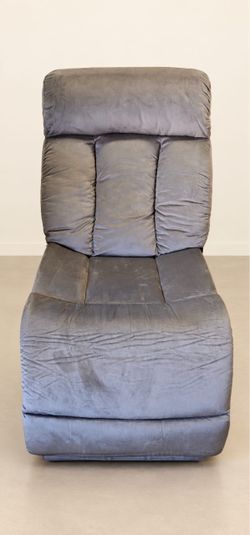 Title: Gray Recliner Chair  Description: Gray recliner chair with soft suede-like upholstery, a padded high back, and a cushioned footrest.