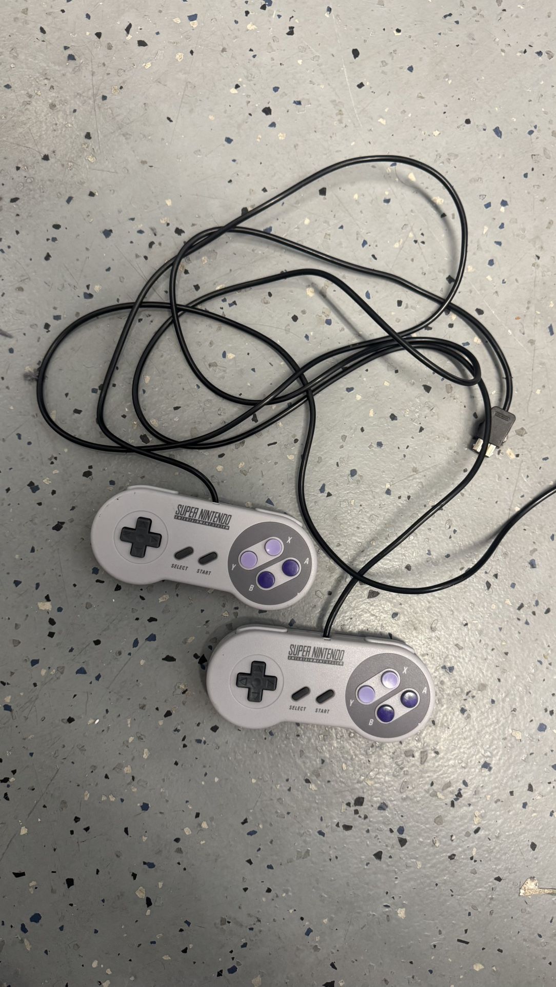 two super Nintendo entertainment system controllers