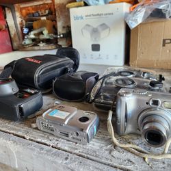 Collection of five cameras and one small tripod