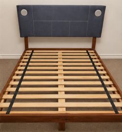 Queen-size bedframe with built-in speaker and a box spring, nightstand and dresser