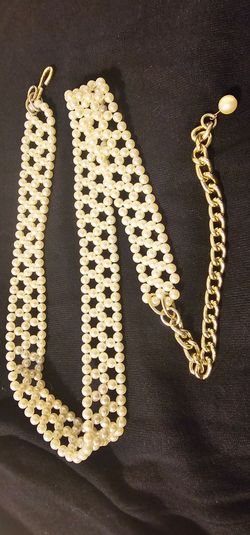 Faux pearl and gold color chain belt.