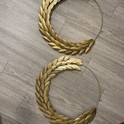 two gold wreath roman style wall decor pieces