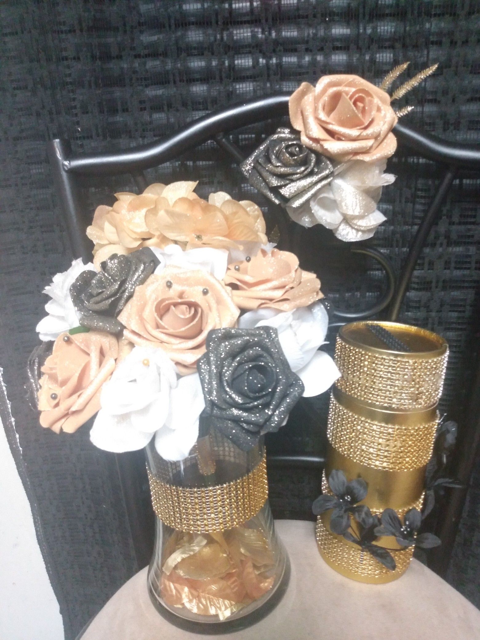 Have $40 set & $50 set Black/Gold/ White roses Includes: boutonniere, & Gold rhinestones Wine gift box. The $50 (2)candles (2)holders & champagne.