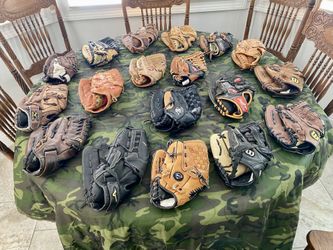 A Grouping Of Left Handed Leather Fielders Gloves