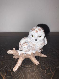 Decorative white owl figurine depicting a larger snowy owl and a smaller owlet perched together