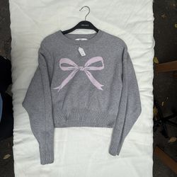 Grey and pink bow jumper (large)
