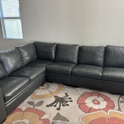 Living Spaces Dark Grey Leather Sectional Couch