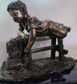 A boy and his dog statue