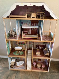 Wooden dollhouse with furniture included.