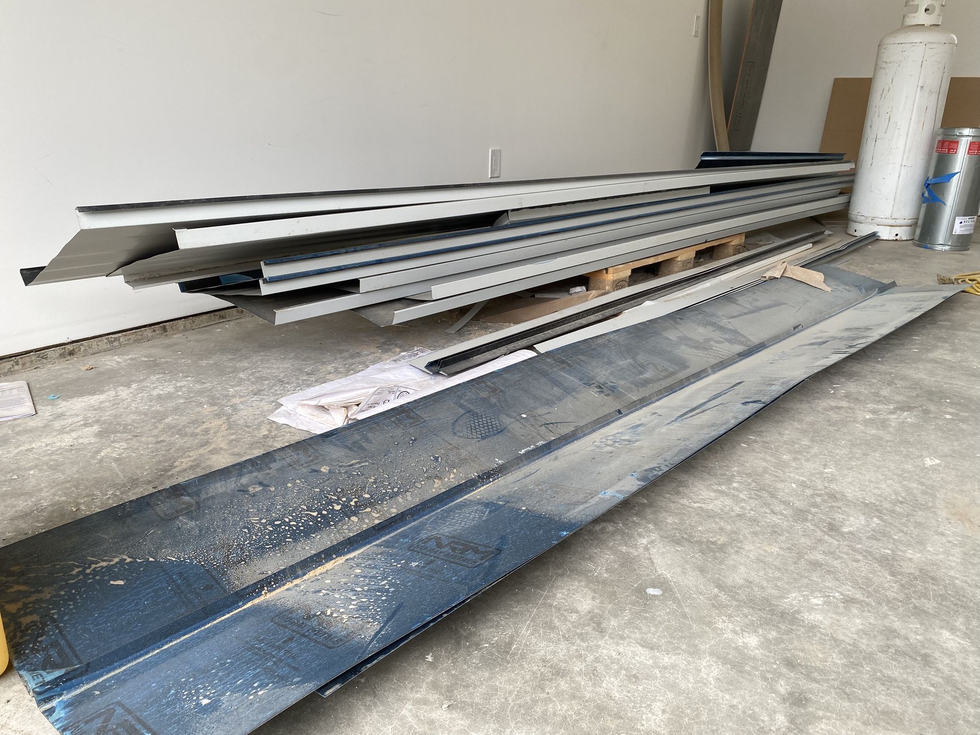 Assorted leftover black Metal Roofing Material