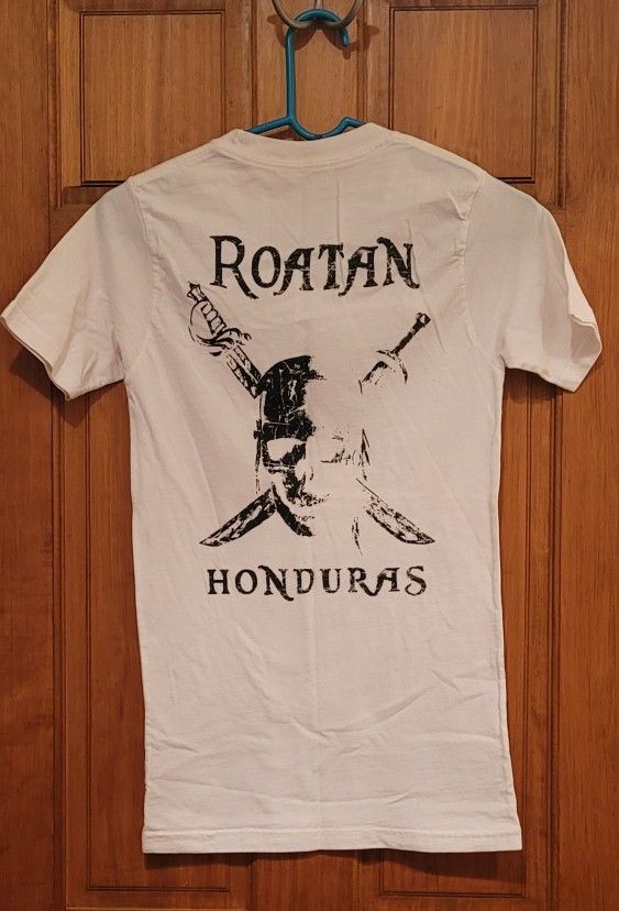 Roatan Honduras t-shirt featuring a pirate-themed graphic. Kids Size? 14"wide
