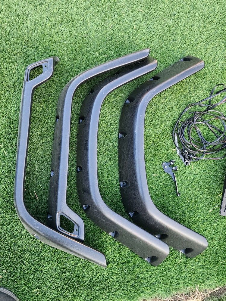 black fender flares for a Jeep Wrangler TJ, likely from the 1(contact info removed) model years.