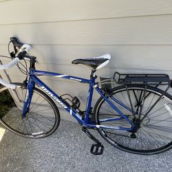 A mountain road bicycle with bike carrier, extra tire inner tubes, extra seat, and bike’s locks 