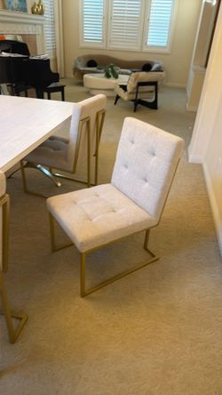 Tufted linen dining chairs with gold frame