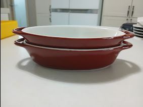 Set of two oval red gratin dishes with handles, baking/serving