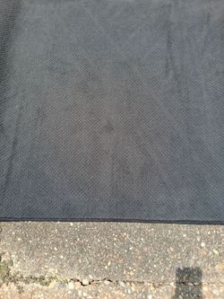 Large dark gray rectangular clsssroom/bedroom area room rug